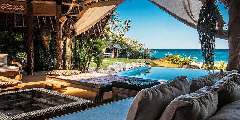 view of ocean over an infinity pool from a luxurious room