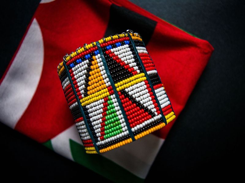 Traditional Maasai bracelet on a backdrop of the Kenyan flag