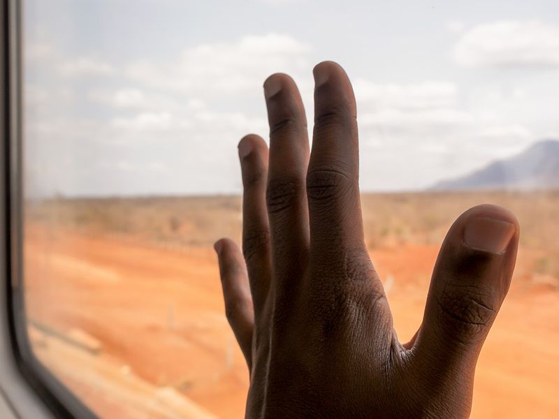 Man looking out of the window of an overland truck