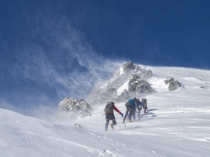 Mountaineers going up a snow capped slope