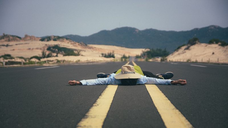 Man lying in the middle of the road