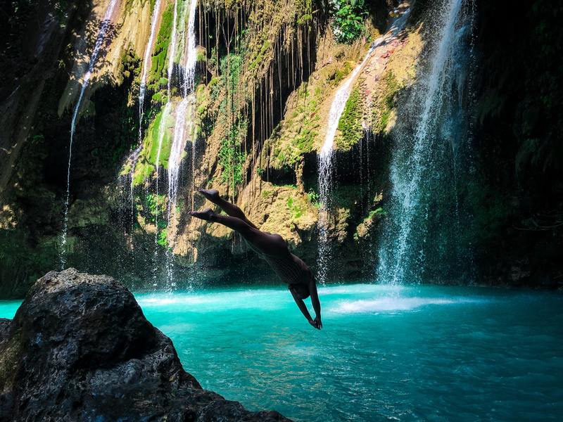 Woman diving into a wild pool for adventure